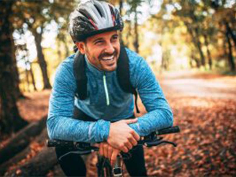 a man smiling on cycle