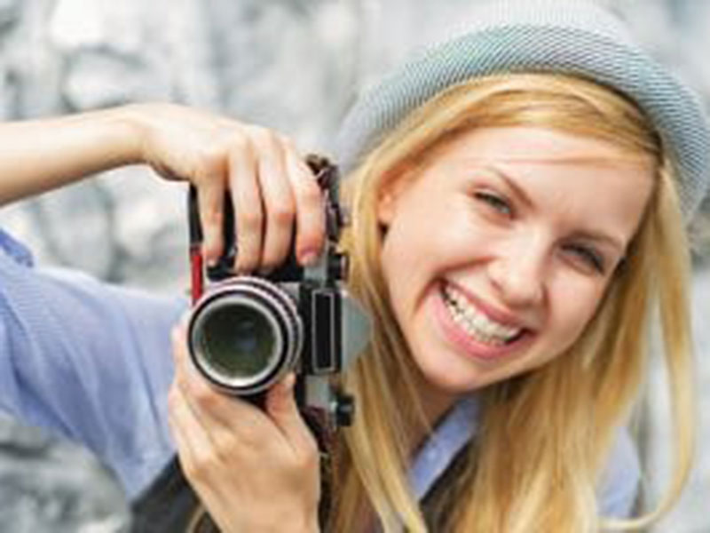a woman clicking pictures with camera
