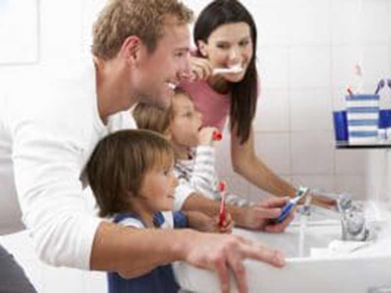 A family brushing teeth together