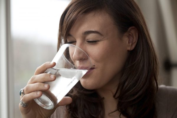 Women is drinking a water