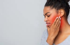 girl suffering with toothache